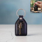 Leather finish keychain featuring metal sword emblem front view