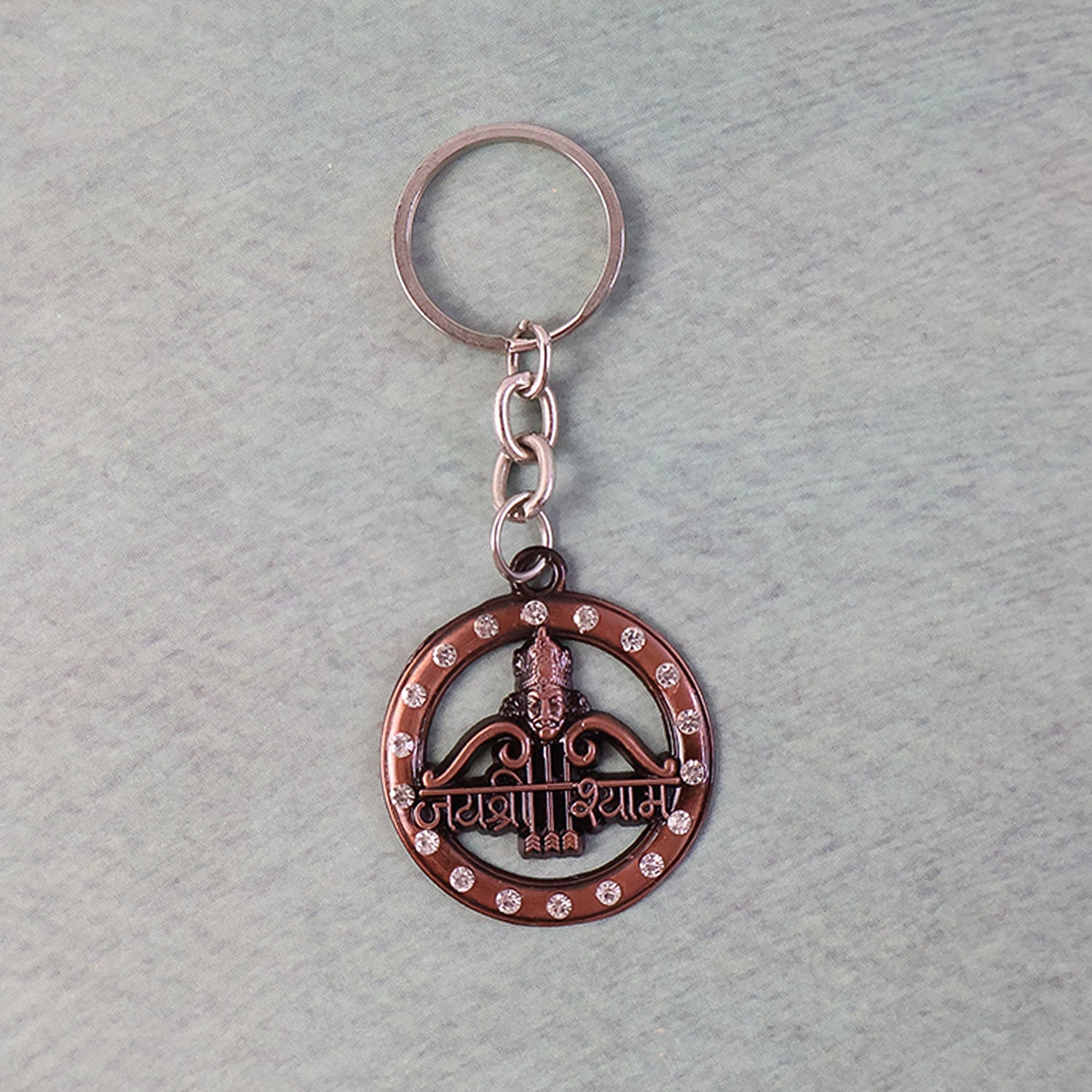 Metal Jai Shree Shyam keychain displaying intricate engraving and crystals
