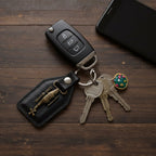 Side angle showing metal sword emblem on leather keychain