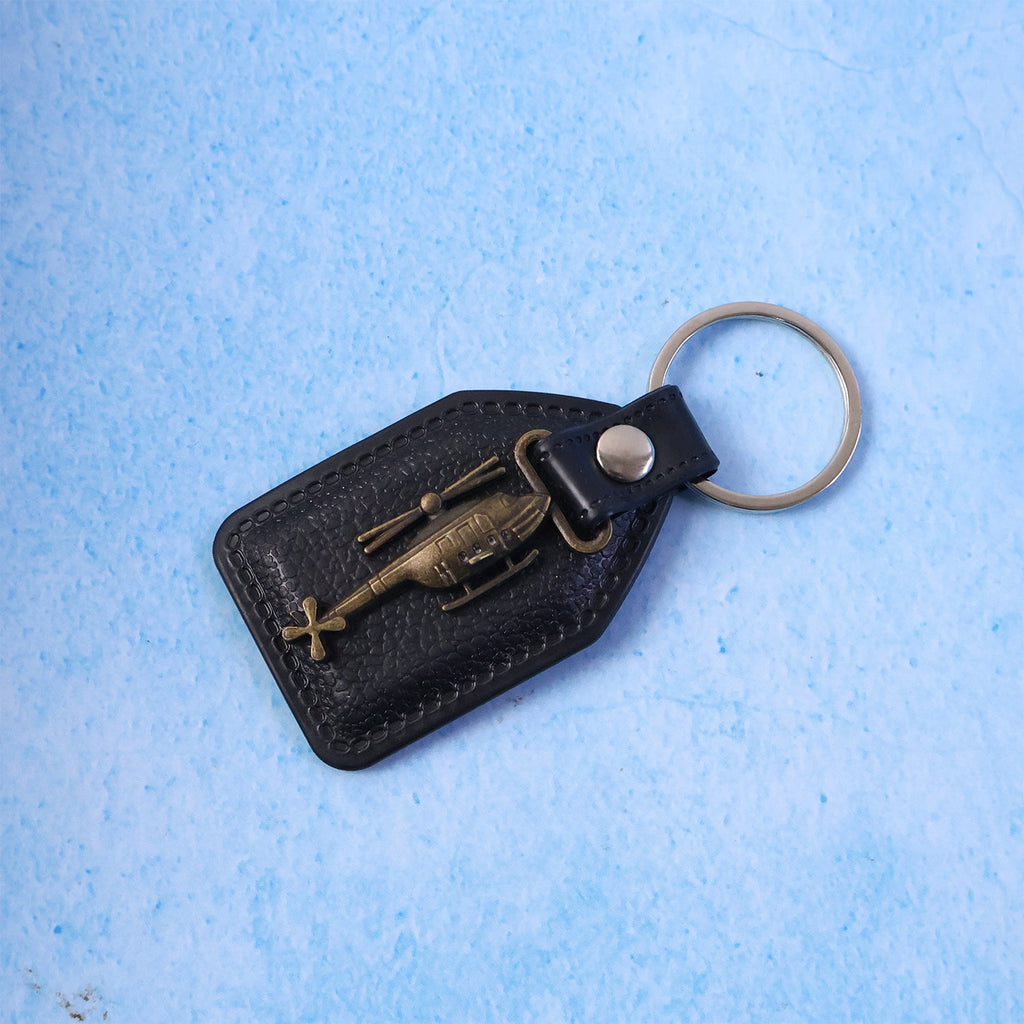 Leather finish base with metal sword emblem keychain hanging