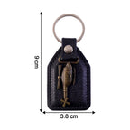 Compact leather and metal sword keychain held in hand