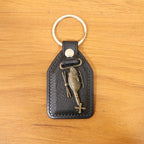 Full display of stylish leather and metal sword emblem keychain