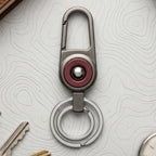 Durable metal key holder with dual rings and locking clip attached to a backpack