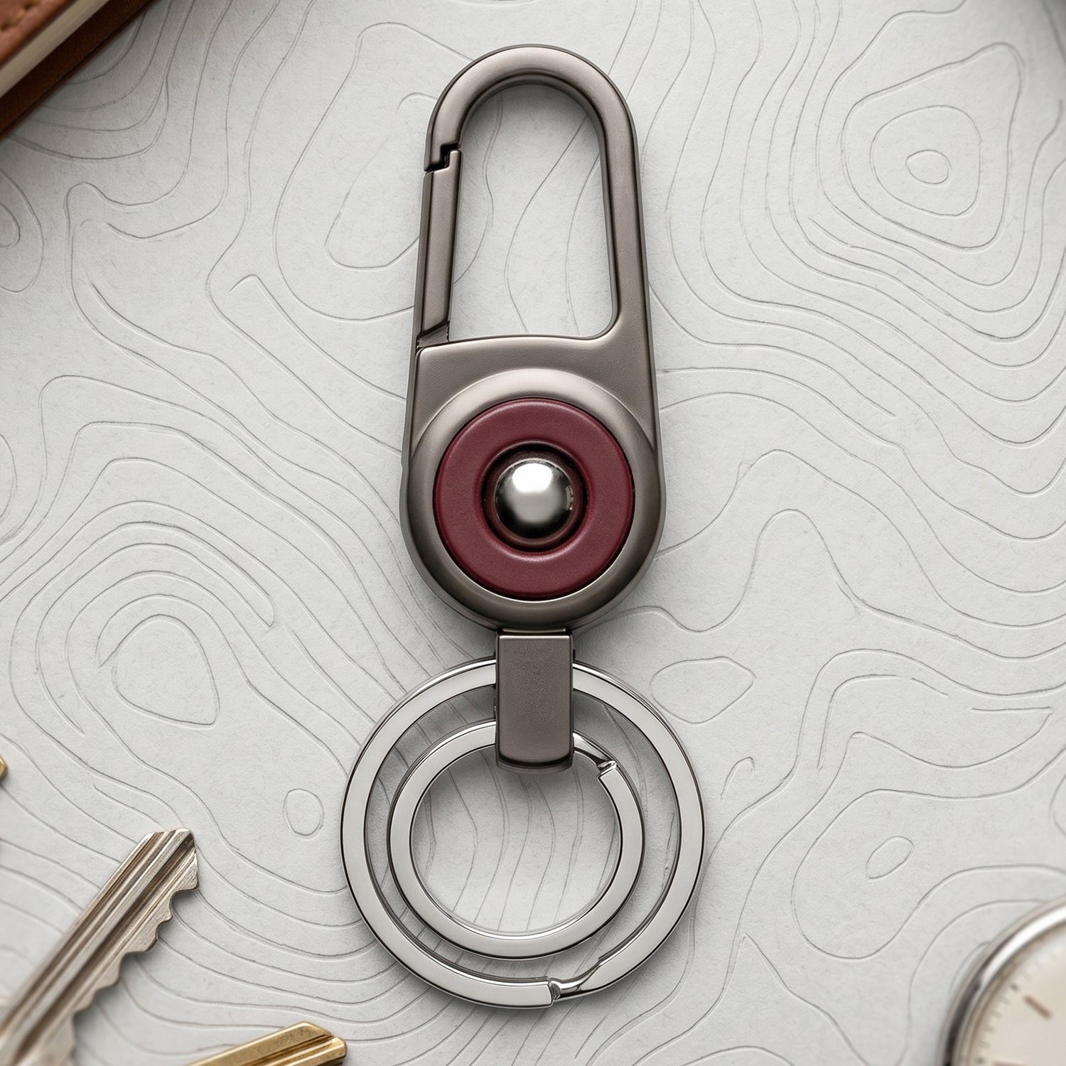Durable metal key holder with dual rings and locking clip attached to a backpack