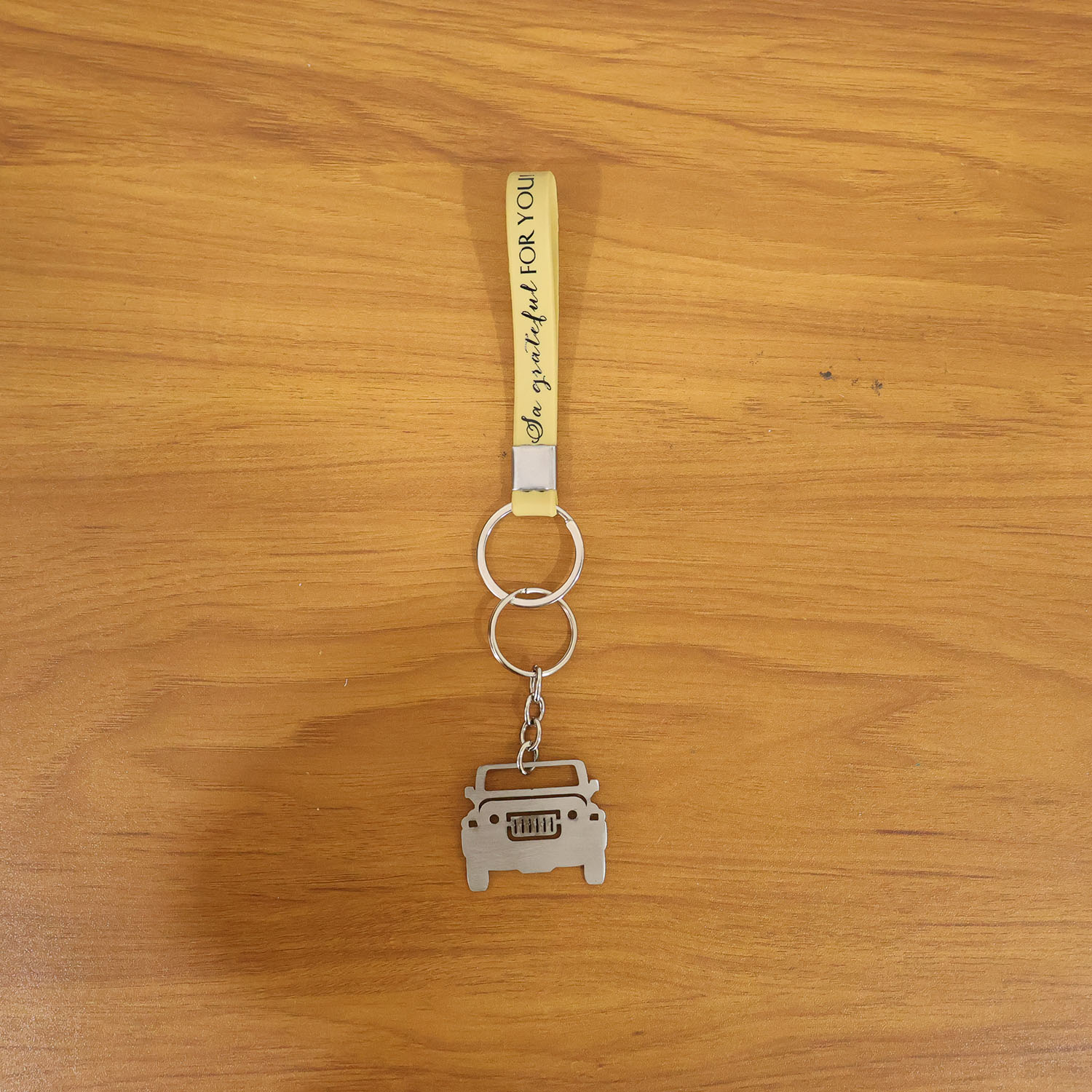 Lifestyle scene showing jeep-shaped metal car keychain in use with keys