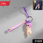 Decorative baby doll silicone keychain hanging from a bag strap
