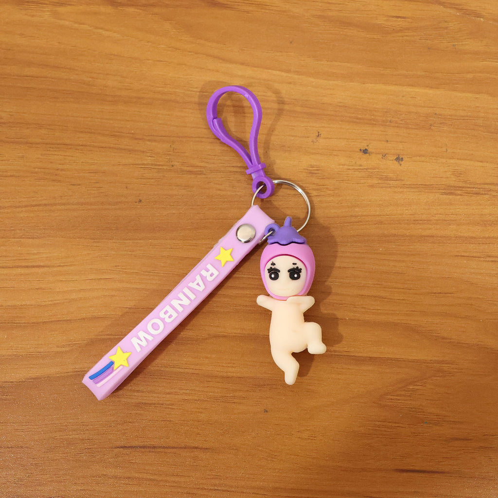 Baby doll silicone keychain in lifestyle setting attached to keys