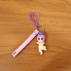 Baby doll silicone keychain in lifestyle setting attached to keys