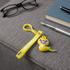 Dinosaur cartoon keychain attached via metal clip to bag zipper