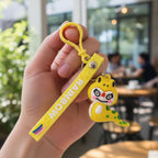 Back view of soft dinosaur keychain featuring colorful rainbow strap