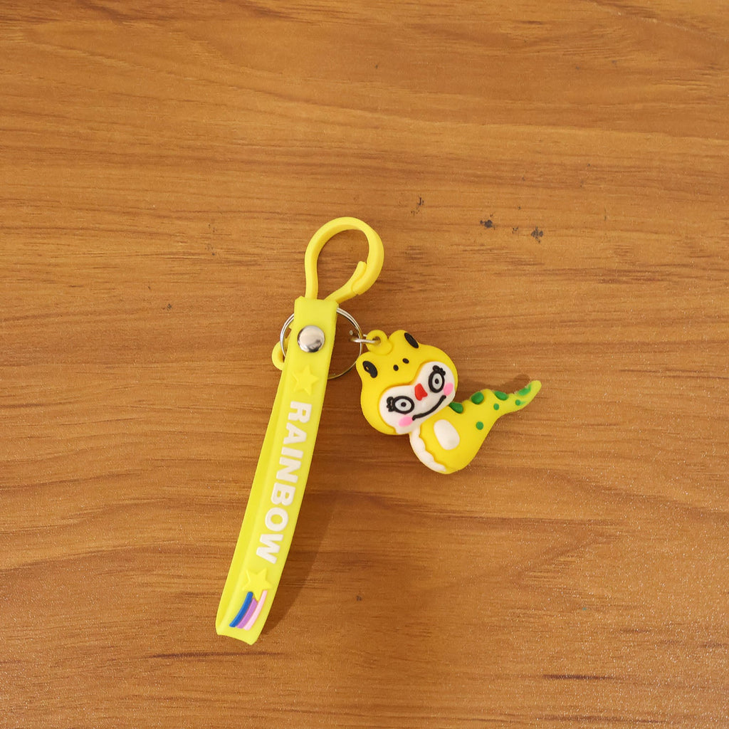 Colorful dinosaur keychain accessory hanging from backpack strap
