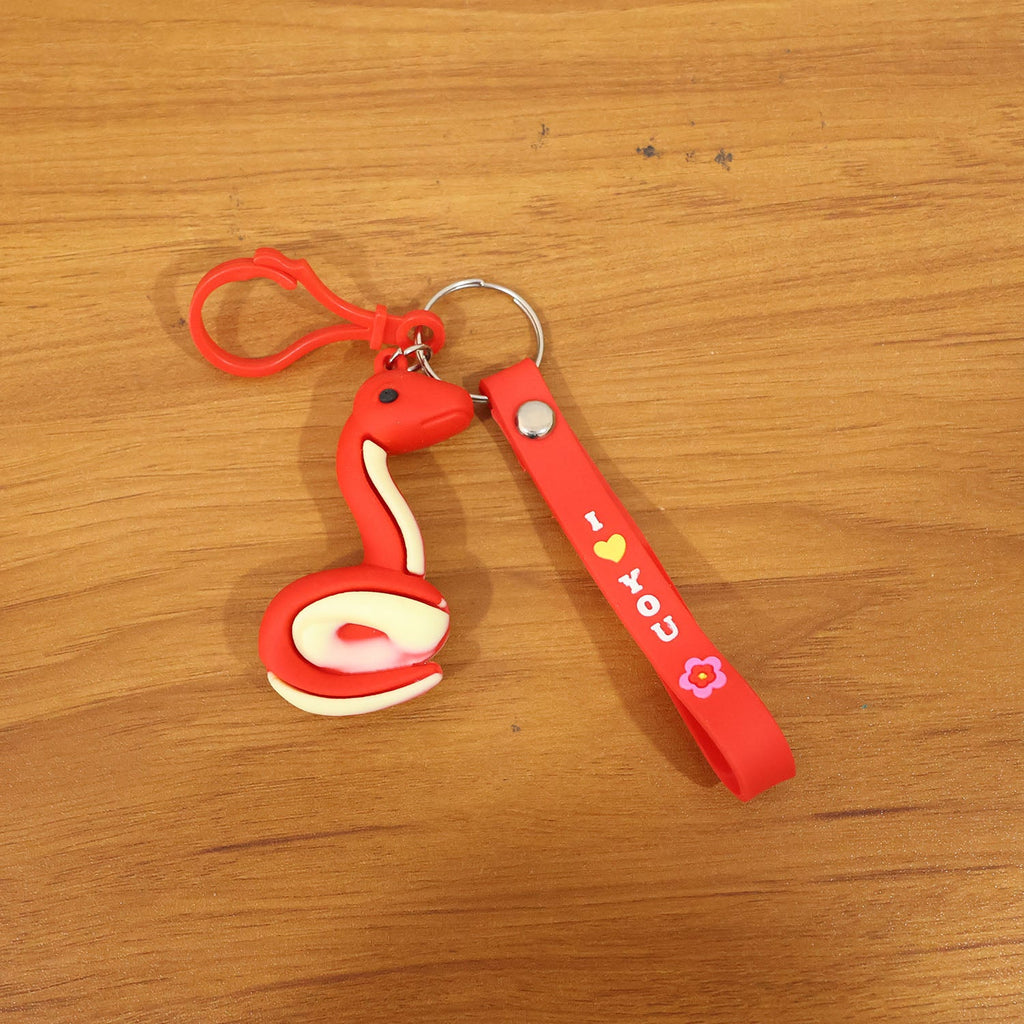 Cartoon snake keychain held in hand displaying size and clip hook