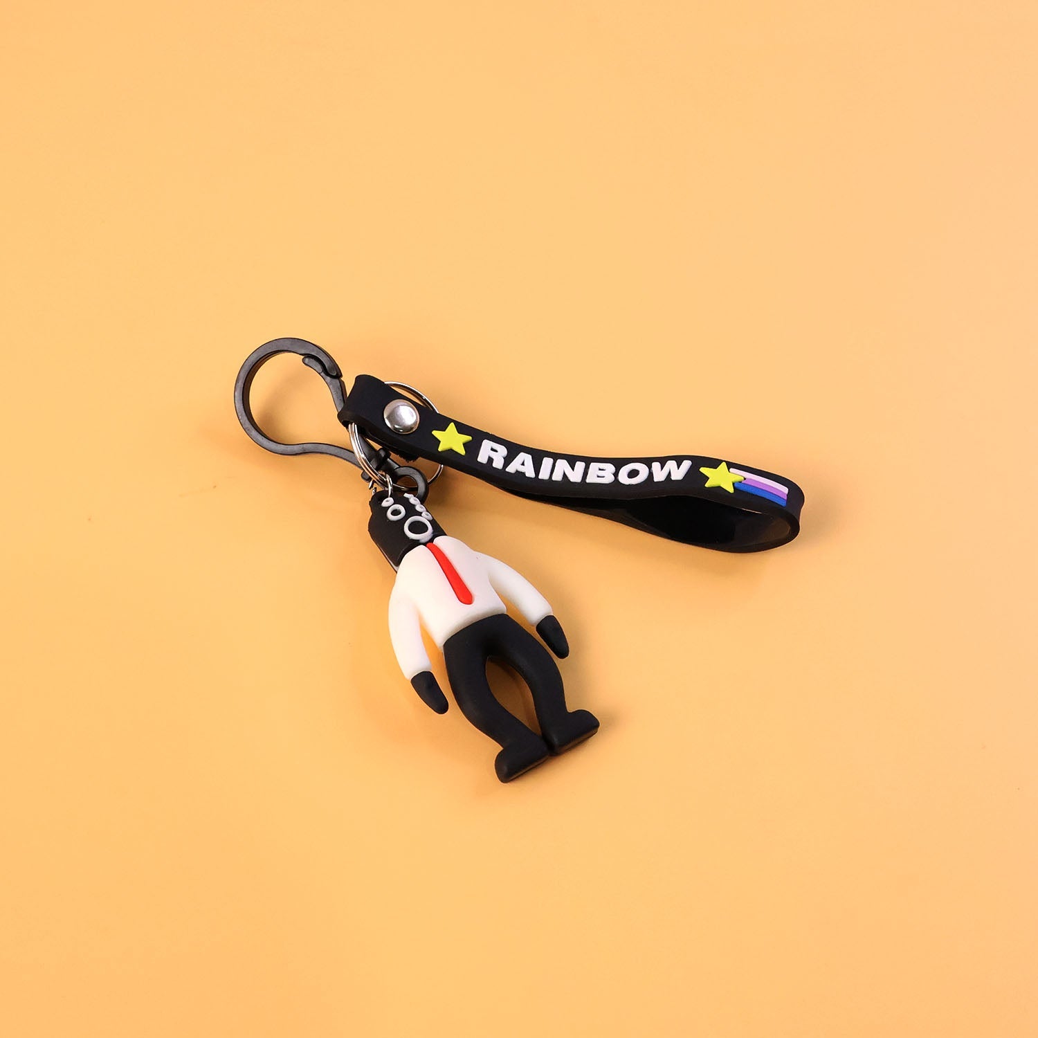 Detailed view of rainbow strap on cartoon man keychain accessory