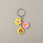 Flower smiley face cartoon keychain showcasing metal ring attachment