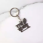 Key pendant attached to Radhe Krishna metal keychain highlighting craftsmanship