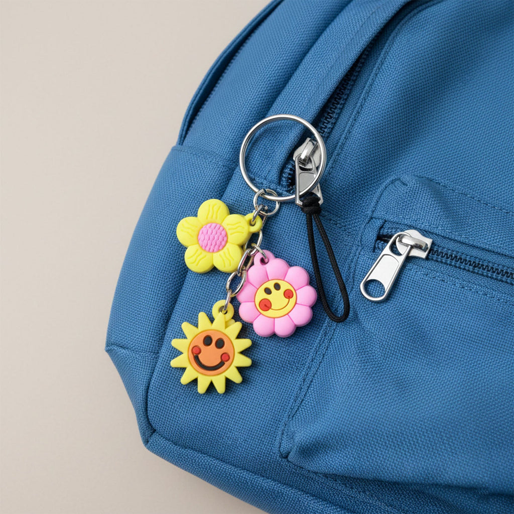 Decorative key holder featuring flower and smiley face charms