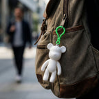 Bear shaped decorative keychain hooked on a backpack zipper