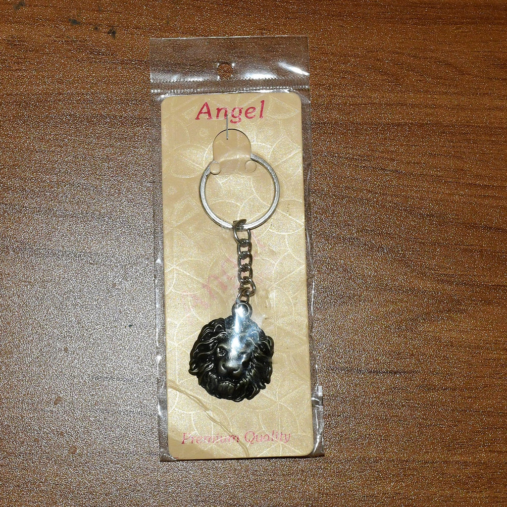 Lion head keychain attached to a set of keys demonstrating practical use