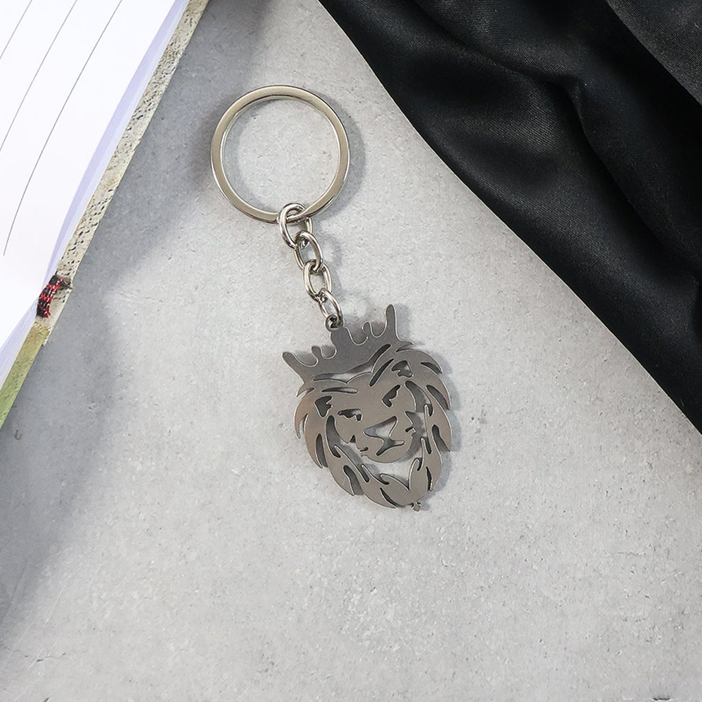 Crowned lion head keychain held in hand showing size and elegant design