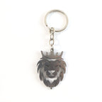 Angled view of metal lion head keychain highlighting textured craftsmanship