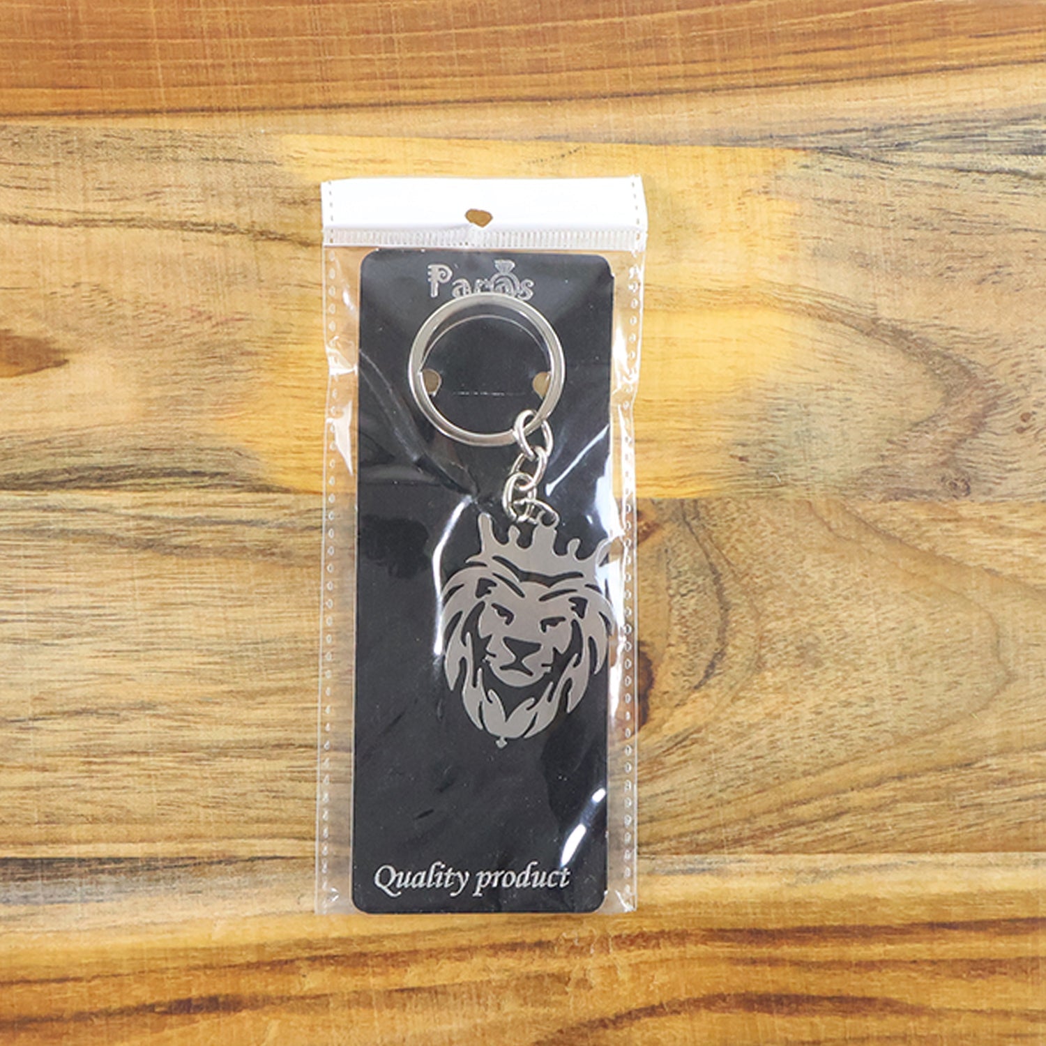 Back view of durable metal lion head keychain with crown design