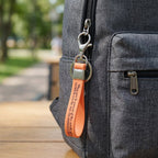 Wrist loop key holder with metal attachment