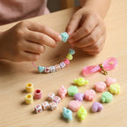Close-up of colourful beads and elastic thread in kids jewellery kit