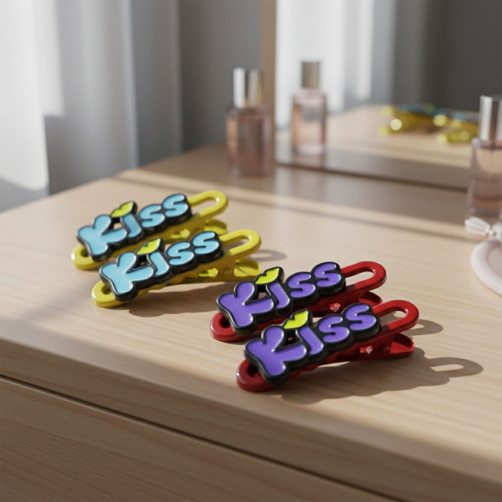 Three Kiss text hair clips arranged on a light background