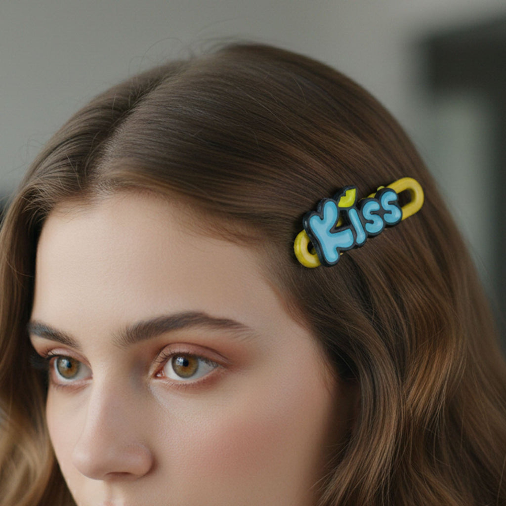 Close-up image of four Kiss text hair clips showing letter design