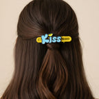Lifestyle image of Kiss text hair clips styled in hair