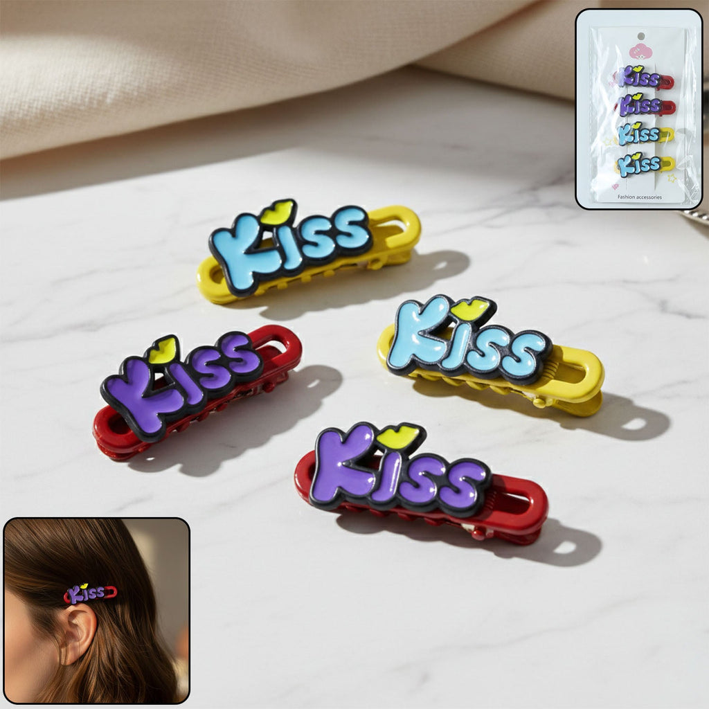 Four decorative Kiss text hair clips arranged on display
