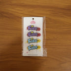 Woman wearing a Kiss text hair clip in long flowing hair