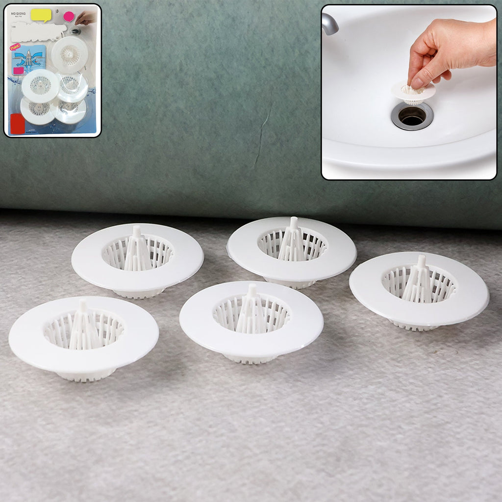 White plastic sink drain hair catcher filter capturing debris
