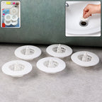 White plastic sink drain hair catcher filter capturing debris