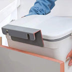 Kitchen dustbin mounted on cabinet door during use