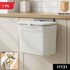 Plastic kitchen dustbin with lid mounted on the wall