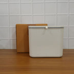 Hygienic kitchen dustbin with closed lid mounted on wall