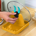 Close-up of kitchen lid and utensil holder stand showing compact design