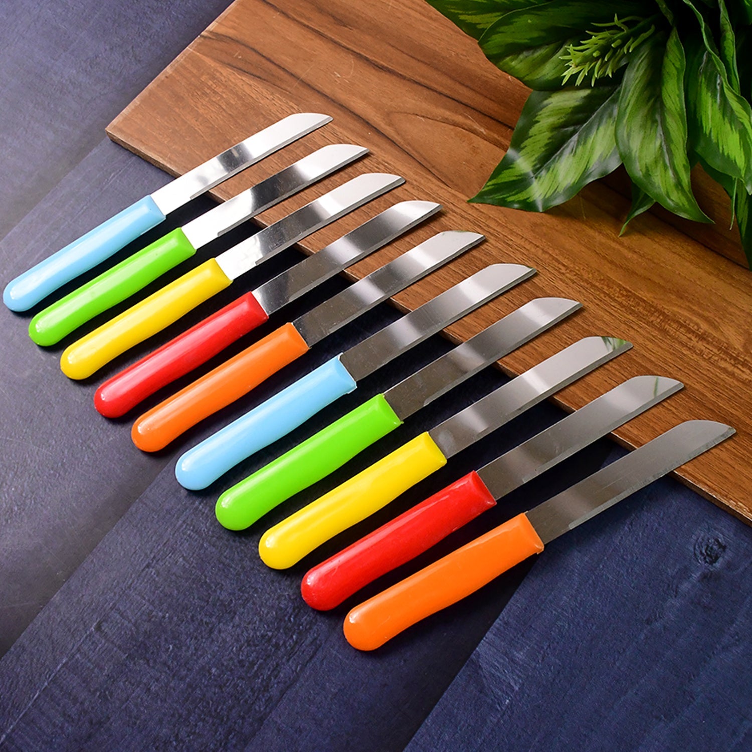10-piece stainless steel kitchen knife set with plastic handles on wooden board