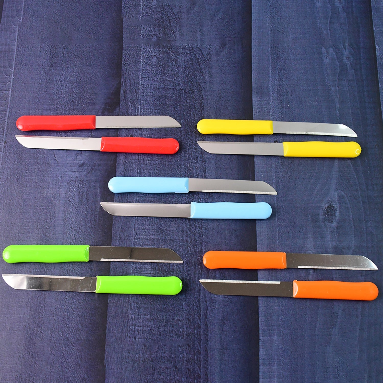 Variety of stainless steel knives with colorful plastic handles for kitchen use