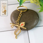 Krishna metal keychain featuring flute and peacock feather design