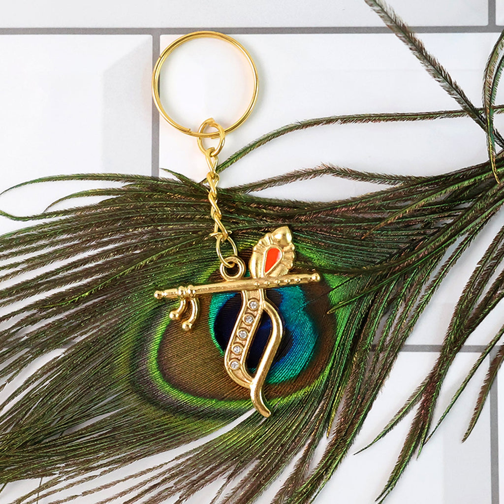 Side view of Krishna metal keychain highlighting flute and peacock feather motif