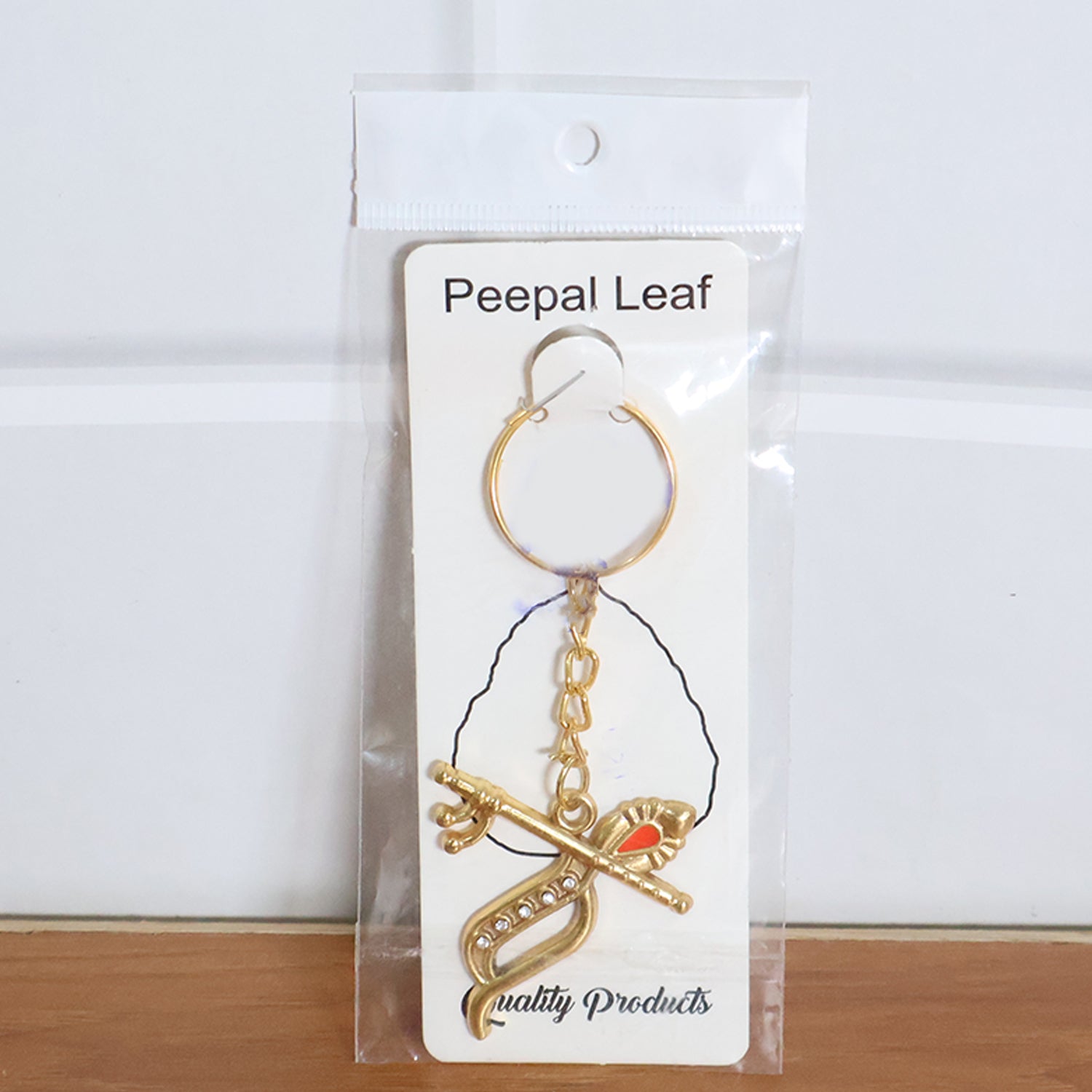 Multiple Krishna metal keychains placed on flat surface, showing consistent design quality
