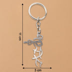 Polished stainless steel Krishna flute keychain on table