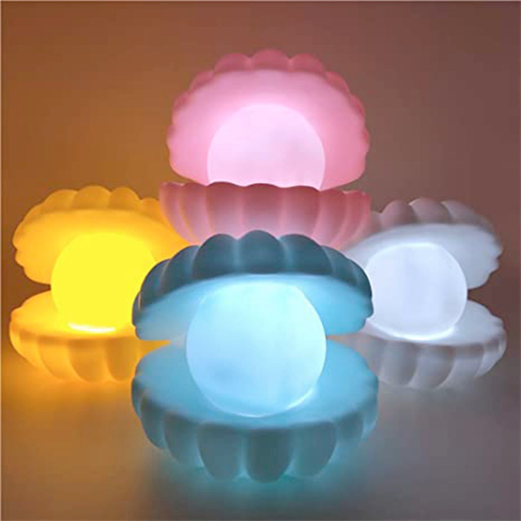 The Pearl Shell Night Lamp lit up, providing a comforting glow in a cozy setting.