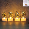 Golden leaf LED candles glowing softly on a dark surface, highlighting intricate details.