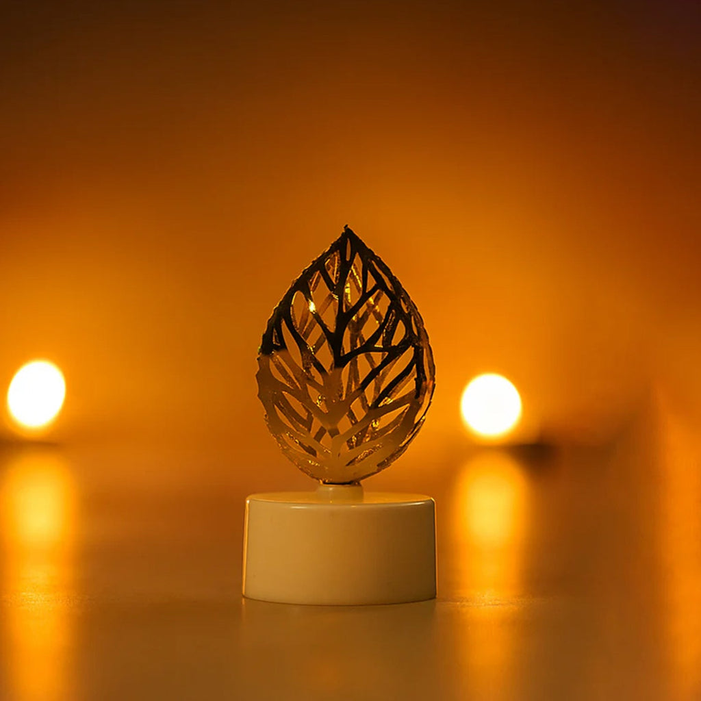Golden leaf LED candles illuminating a festive setting, creating a serene ambience.