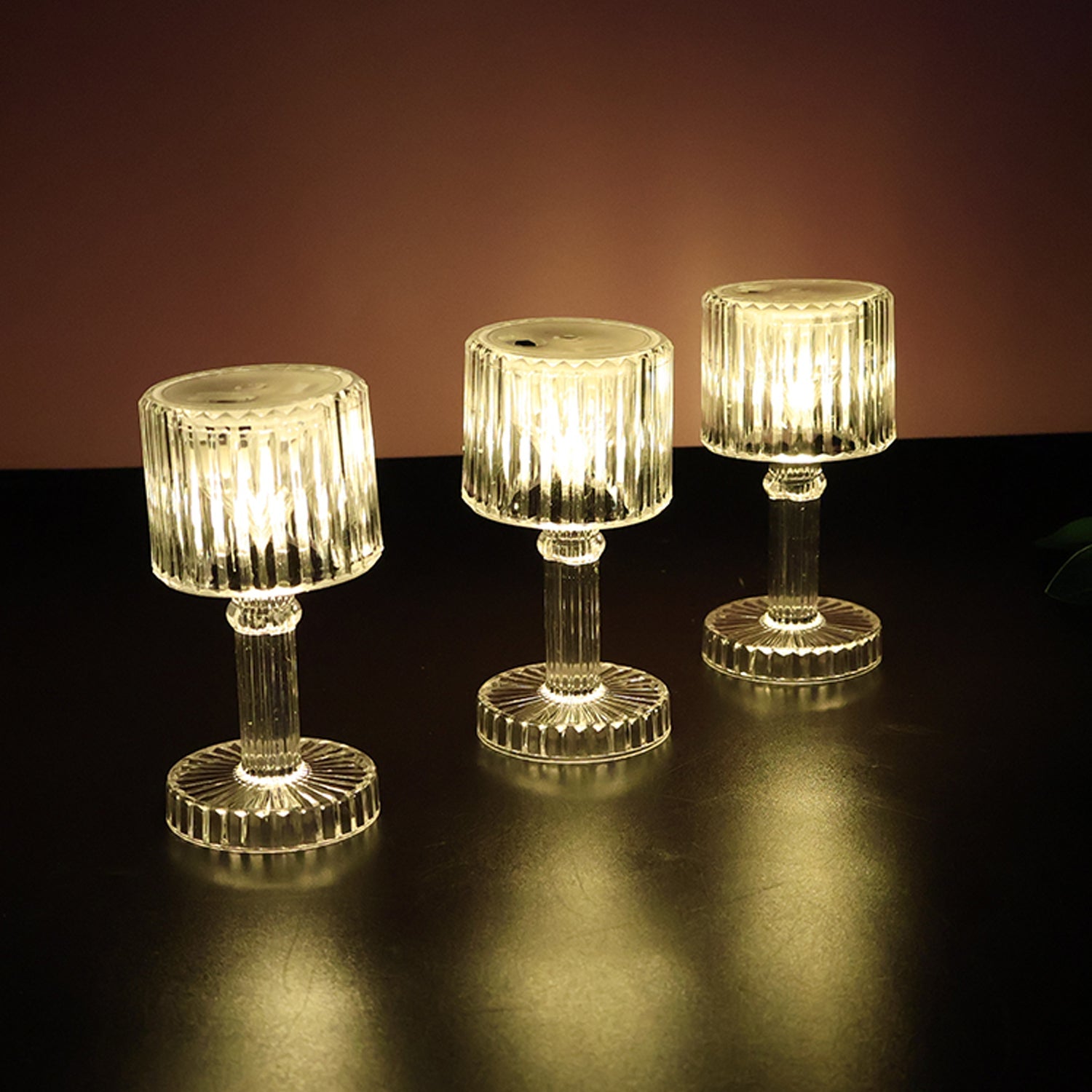 Multiple LED crystal-effect lamps arranged on table for festive decor