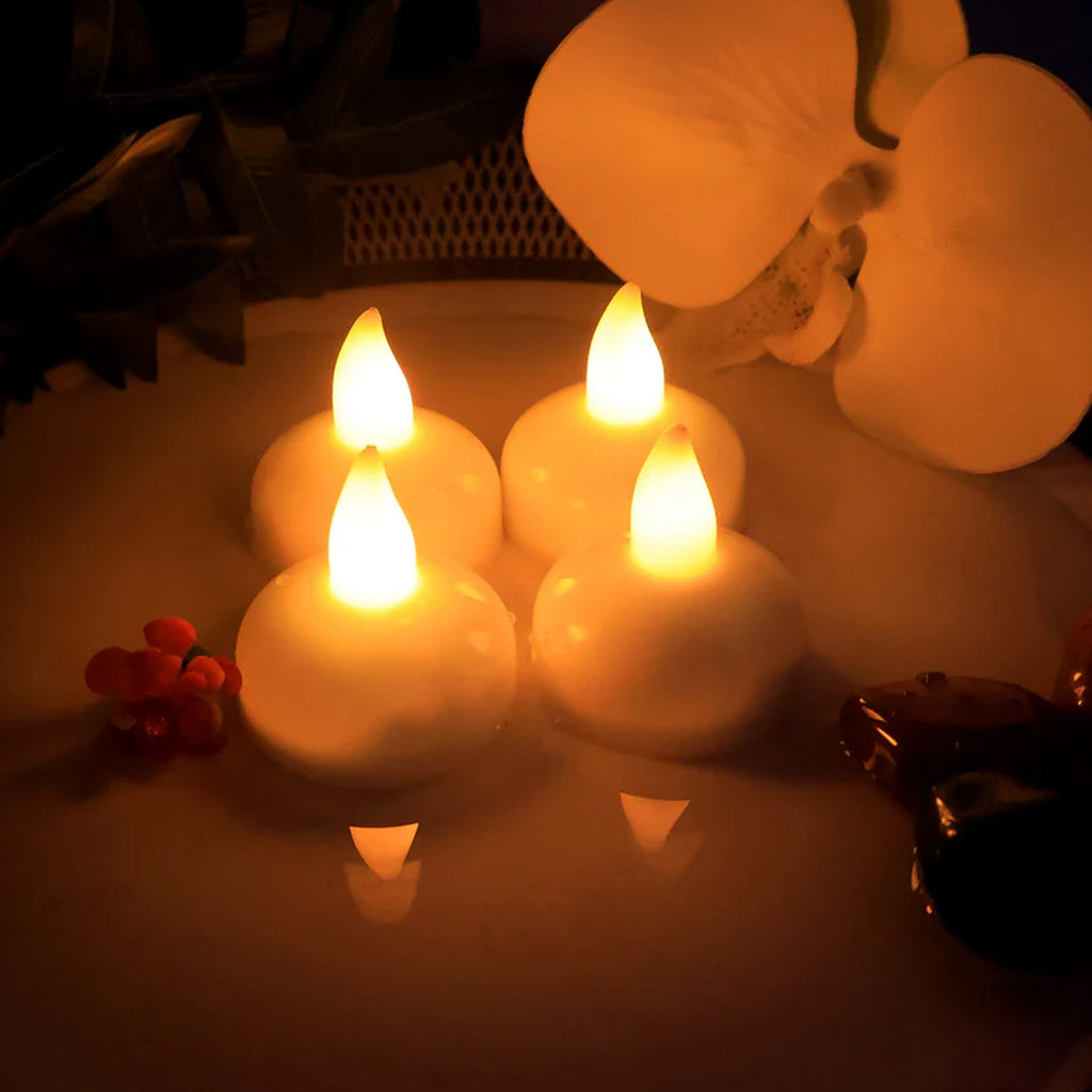 Eight LED flameless tealight candles arranged showing realistic flickering flame effect