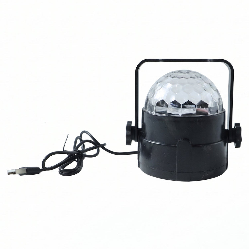 Hand holding the small USB powered star projector light, highlighting its compact size.